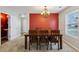 Bright dining room features a striking red accent wall and a modern chandelier fixture at 6904 Estepona St, Atlanta, GA 30349