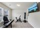 Bright exercise room filled with equipment and bathed in natural light from two windows at 6904 Estepona St, Atlanta, GA 30349