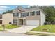Lovely 2 story house with a 2 car garage, green lawn, and nice landscaping at 6904 Estepona St, Atlanta, GA 30349