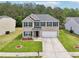 Attractive two-story home with brick accents, green shutters, an attached garage, and a well-maintained front lawn at 6904 Estepona St, Atlanta, GA 30349