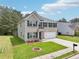 Lovely home with a brick and siding exterior, complemented by green shutters and a spacious two-car garage at 6904 Estepona St, Atlanta, GA 30349