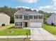 Beautiful two-story home featuring a brick facade, green shutters, a well-kept lawn, and a two-car garage at 6904 Estepona St, Atlanta, GA 30349