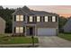 Charming two-story brick home with well-manicured lawn and attached two-car garage at 6904 Estepona St, Atlanta, GA 30349