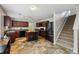 Spacious kitchen with dark wood cabinets, a center island, and modern black appliances at 6904 Estepona St, Atlanta, GA 30349