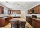 This kitchen offers wood cabinets, sleek black appliances, and a cozy center island with seating at 6904 Estepona St, Atlanta, GA 30349