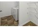 Utility room with washer, dryer, and shelving, blending functionality with home design at 6904 Estepona St, Atlanta, GA 30349