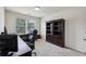 Office features a dark wooden bookcase and a large window at 6904 Estepona St, Atlanta, GA 30349