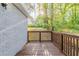 Side angle of deck with white brick exterior, lawn, and trees at 2910 Diana Sw Dr, Atlanta, GA 30315