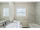 Updated bathroom features modern granite vanity, white tile, and a shower-tub combo at 2910 Diana Sw Dr, Atlanta, GA 30315