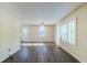 Bright living room showcasing laminate flooring, fresh paint, and natural light from large windows at 2910 Diana Sw Dr, Atlanta, GA 30315