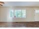 Inviting living room featuring laminate flooring, fresh paint, and natural light from large windows at 2910 Diana Sw Dr, Atlanta, GA 30315