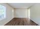Well-lit room with new laminate flooring and a freshly painted white door for a modern feel at 2910 Diana Sw Dr, Atlanta, GA 30315