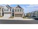 Beautiful townhome with a two-car garage and charming brick and siding exterior at 7676 Viking Rd, Fairburn, GA 30213