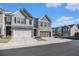 Beautiful townhome with a two-car garage and charming brick and siding exterior at 7676 Viking Rd, Fairburn, GA 30213