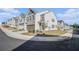 Charming neighborhood street view showcasing craftsman-style townhomes with attached garages at 7676 Viking Rd, Fairburn, GA 30213