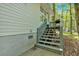 Back porch with stairs, grill, railing, and view of trees at 113 Fowler Dr, Bowdon, GA 30108