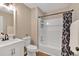 Well-lit bathroom with a modern vanity, decorative shower curtain, and built-in shelves at 113 Fowler Dr, Bowdon, GA 30108