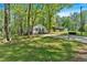 Exterior view of a beautiful home with a lush green lawn and surrounding trees at 113 Fowler Dr, Bowdon, GA 30108