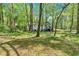 Exterior of home with a front porch surrounded by mature trees providing a private setting at 113 Fowler Dr, Bowdon, GA 30108