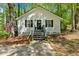 Charming exterior with an American flag, flower pots, a black door, and black shutters at 113 Fowler Dr, Bowdon, GA 30108