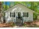 Charming exterior with an American flag, flower pots, a black door, and black shutters at 113 Fowler Dr, Bowdon, GA 30108