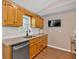 Traditional kitchen features wooden cabinets, granite counters, tile backsplash, and stainless steel dishwasher at 113 Fowler Dr, Bowdon, GA 30108