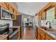 View of kitchen flowing into dining area, complete with stainless steel appliances and granite counters at 113 Fowler Dr, Bowdon, GA 30108