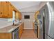 A galley style kitchen features wood cabinets, white subway tile backsplash, and stainless appliances at 113 Fowler Dr, Bowdon, GA 30108
