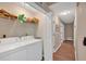 Convenient laundry room with washer, dryer, shelving, and hallway access at 113 Fowler Dr, Bowdon, GA 30108