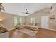 A spacious living room with a large sectional sofa, high ceilings, and lots of natural light at 113 Fowler Dr, Bowdon, GA 30108