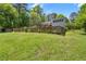Large backyard with fenced perimeter features a shed and home's exterior with upper and lower deck at 135 Longview Rd, Fayetteville, GA 30214