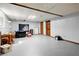 Spacious unfinished basement with painted walls, a window for natural light, and two doors at 135 Longview Rd, Fayetteville, GA 30214