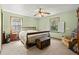 Bedroom with a wooden bed, vintage trunk, and two windows at 135 Longview Rd, Fayetteville, GA 30214