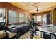 Cozy bedroom featuring wood-paneled walls, natural light from multiple windows, and unique flooring at 135 Longview Rd, Fayetteville, GA 30214