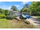 View of home with side garage and long driveway on a sunny day at 135 Longview Rd, Fayetteville, GA 30214