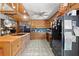 Well-lit kitchen with wooden cabinets, modern appliances, and tiled floor at 135 Longview Rd, Fayetteville, GA 30214