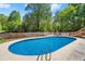 Inviting in-ground swimming pool surrounded by lounge seating, perfect for relaxing and enjoying the outdoors at 135 Longview Rd, Fayetteville, GA 30214