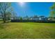 Expansive, grass-covered backyard with a wooden fence and mature trees, perfect for outdoor activities and privacy at 1401 Kala Dr, Lithonia, GA 30058