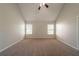 Bright bedroom with carpet flooring, neutral tones, and two windows for natural light at 1401 Kala Dr, Lithonia, GA 30058
