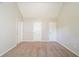 Empty bedroom with neutral walls and carpet, and three doors at 1401 Kala Dr, Lithonia, GA 30058
