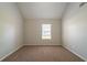 Empty bedroom with neutral walls and carpet, with one window at 1401 Kala Dr, Lithonia, GA 30058
