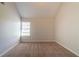Empty bedroom with neutral walls and carpet, with one window at 1401 Kala Dr, Lithonia, GA 30058