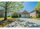 Charming brick home with a two-car garage and a well-maintained front yard and driveway at 1401 Kala Dr, Lithonia, GA 30058