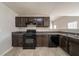 Well-lit kitchen featuring brown cabinets, black appliances, and durable countertops at 1401 Kala Dr, Lithonia, GA 30058