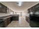 View of a modern kitchen, with dark cabinets, an open layout, and durable tile flooring at 1401 Kala Dr, Lithonia, GA 30058