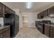 Traditional kitchen with brown cabinets, granite countertops, and black appliances at 1401 Kala Dr, Lithonia, GA 30058