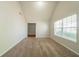 Bright living room featuring neutral walls, plush carpeting and a large window at 1401 Kala Dr, Lithonia, GA 30058