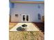 Backyard featuring a concrete patio with a stone fire pit, connecting to the house at 3723 Verde Glen Ln, Cumming, GA 30040