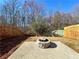 Spacious fenced backyard with concrete patio, and stone fire pit, great for outdoor enjoyment at 3723 Verde Glen Ln, Cumming, GA 30040