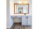 Well-lit bathroom vanity with a wood-framed mirror and storage cabinets at 3723 Verde Glen Ln, Cumming, GA 30040